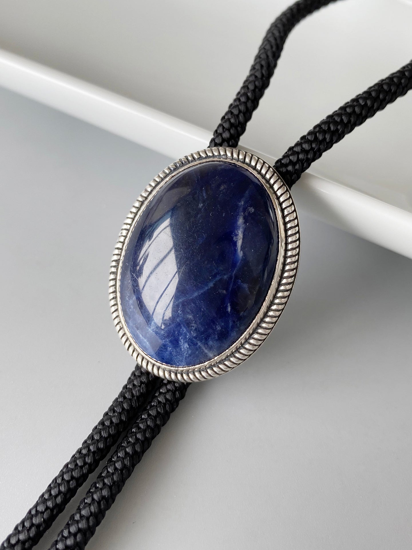 The Abyssal Tide · Sodalite Bolo Tie in Sterling Silver